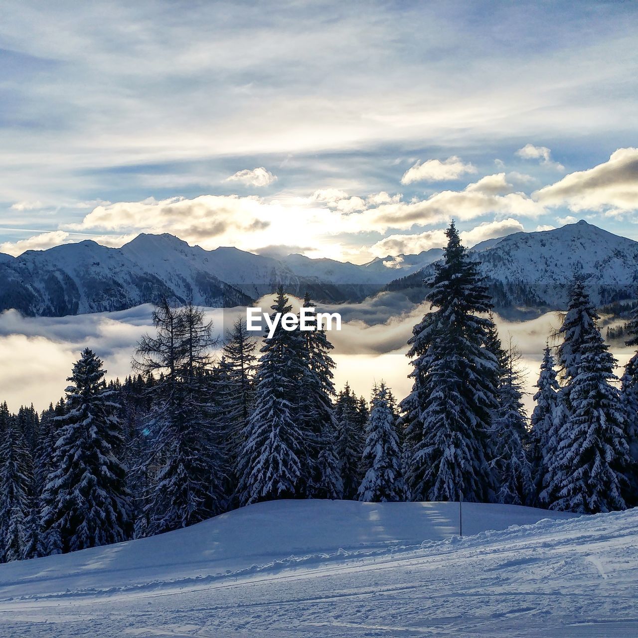 Scenic view of snow covered mountains against sky