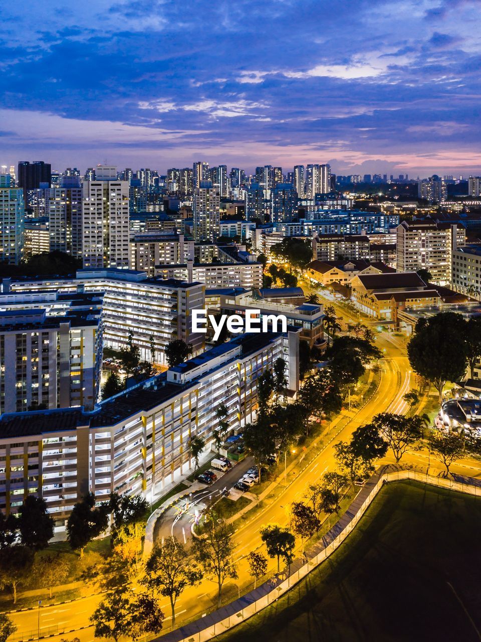 High angle view of illuminated street amidst buildings in city