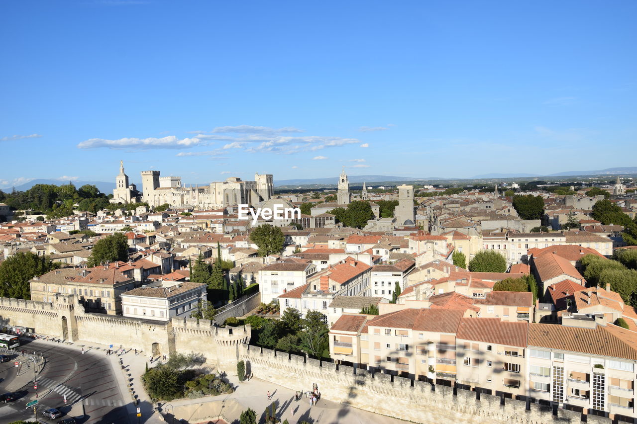 High angle view of cityscape against blue sky