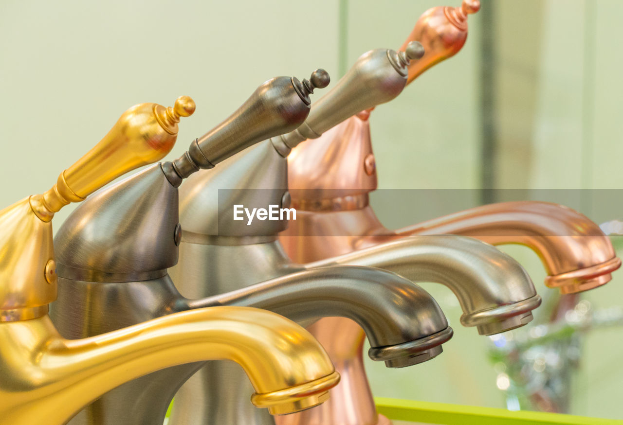 LOW ANGLE VIEW OF FIGURINE ON METAL PIPES