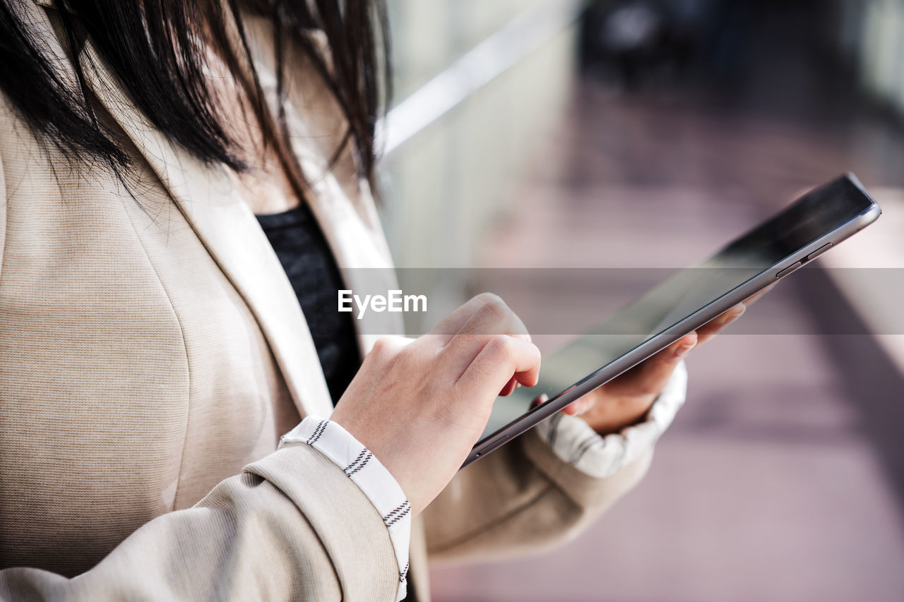 Unrecognizable business woman using digital tablet in office, co working, technology