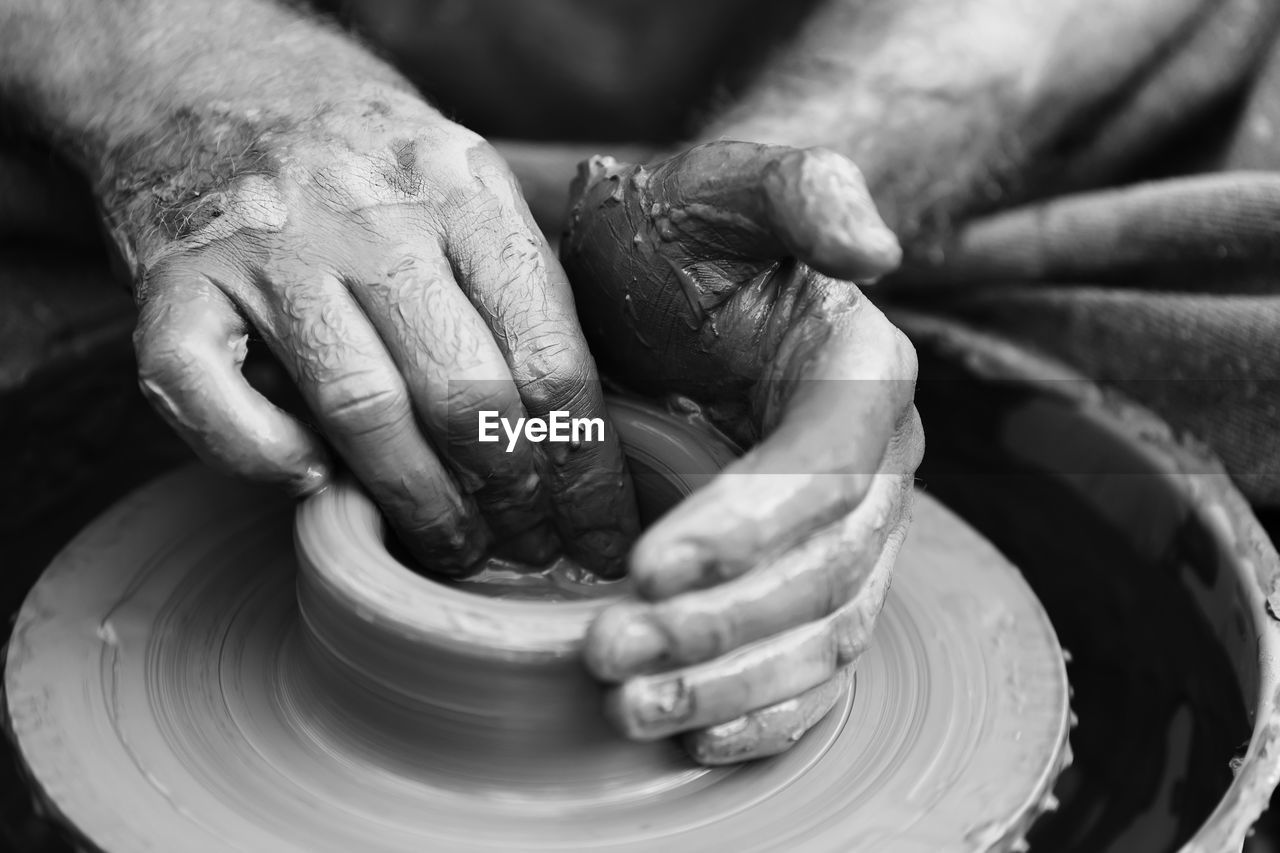 Hands of a potter. potter making ceramic pot on the pottery wheel