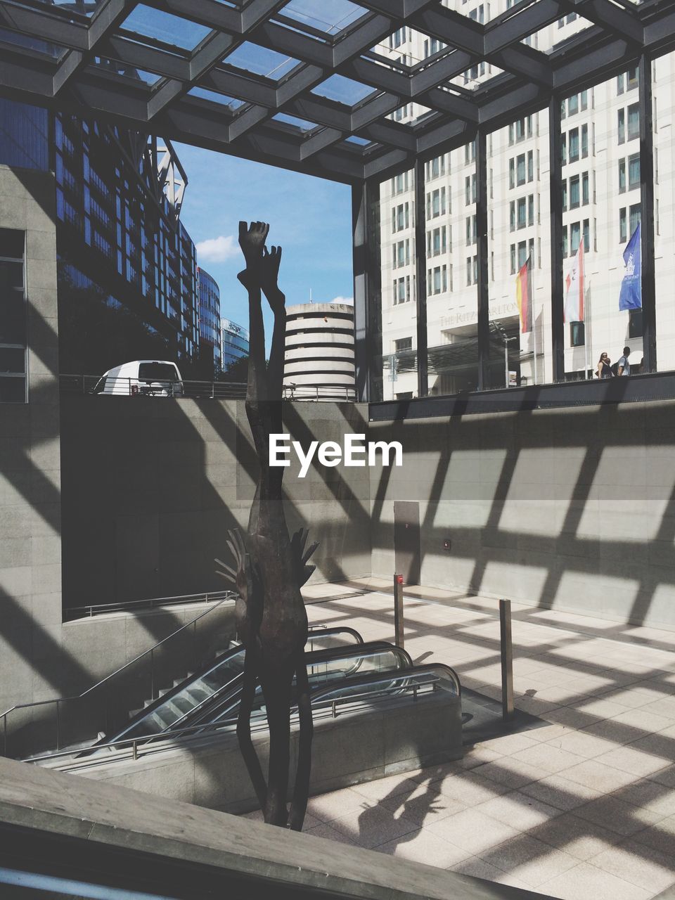 WOMAN STANDING IN FRONT OF BUILDING