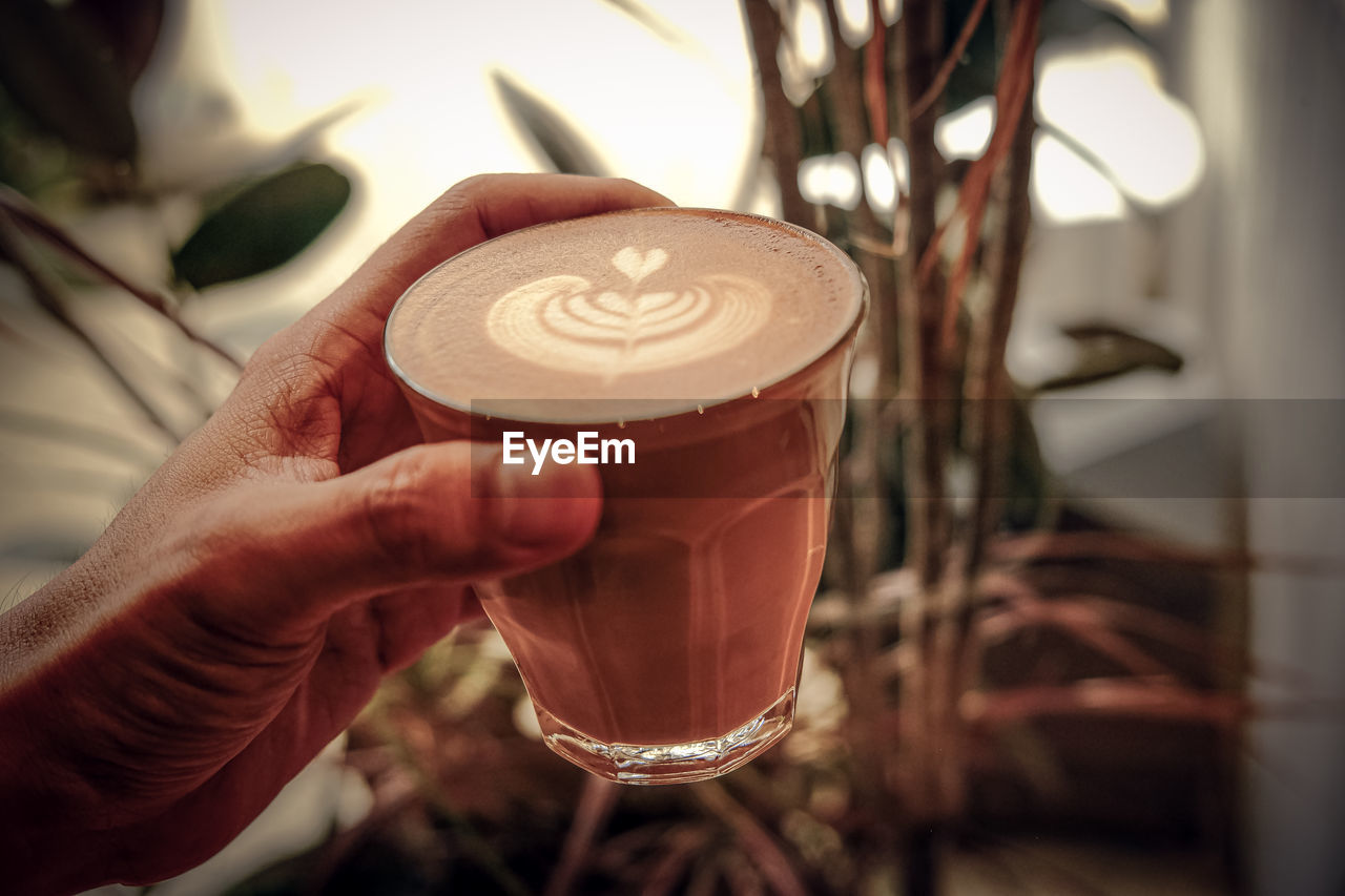 hand, drink, food and drink, holding, refreshment, one person, adult, coffee, indoors, frothy drink, close-up, focus on foreground, latte, cup, cappuccino, food, hot drink, alcoholic beverage, freshness