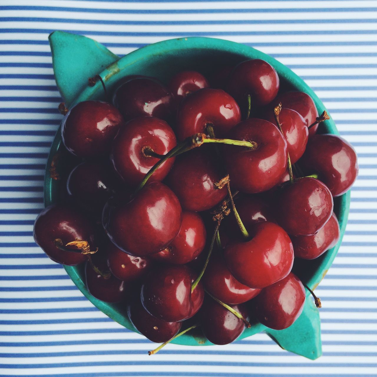 Directly above shot of cherries in bowl on table indoors