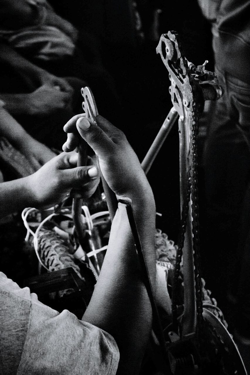 Cropped hands holding metal at night