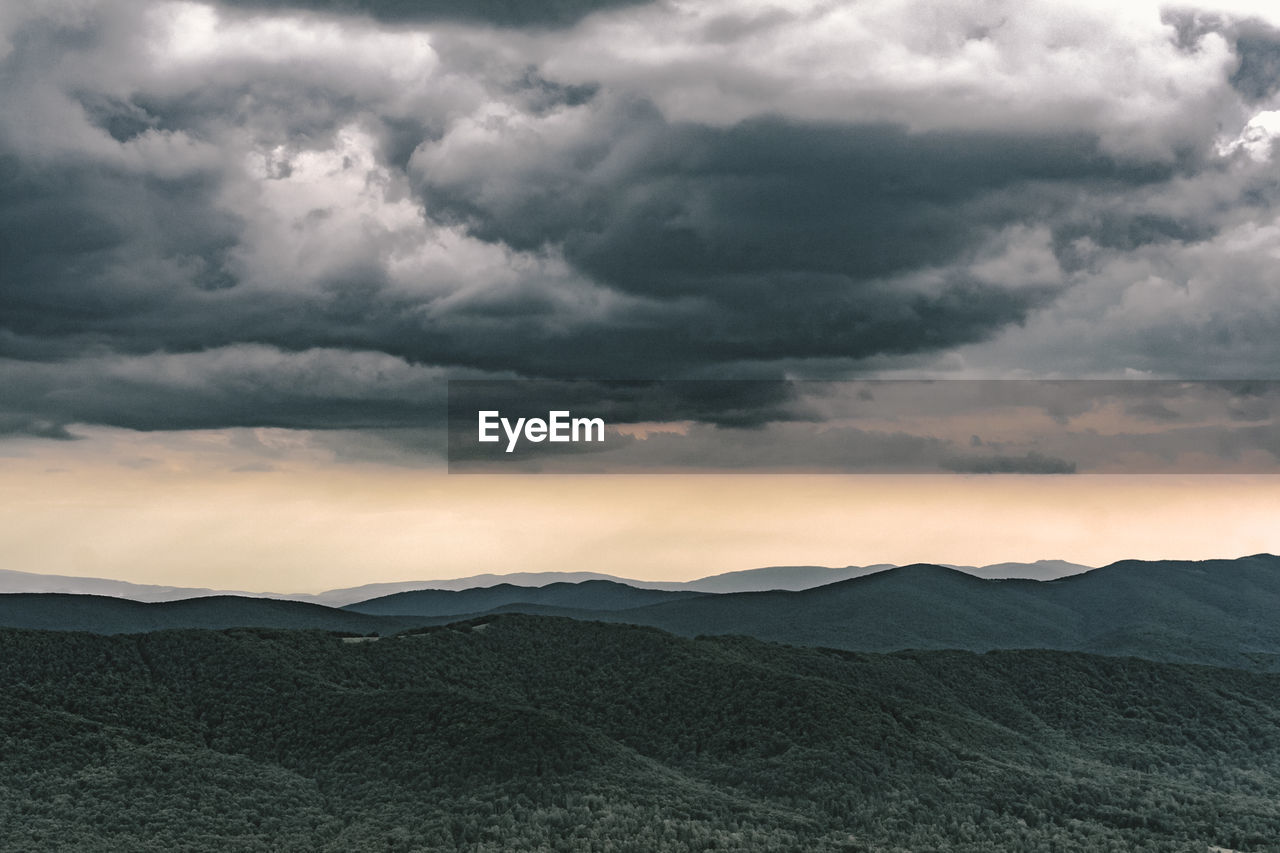 Scenic view of landscape against dramatic sky