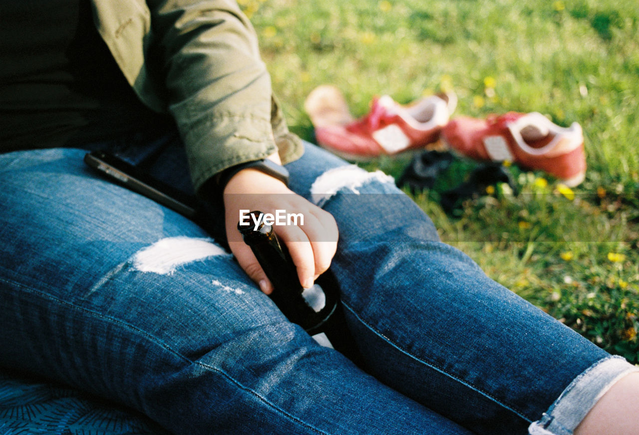 Low section of man sitting on grass