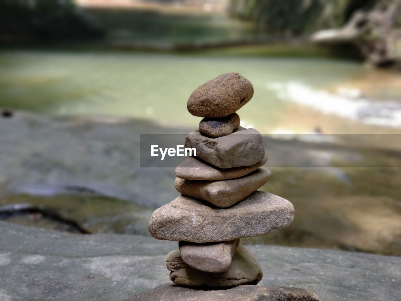 Close-up of stone stack on rock in river