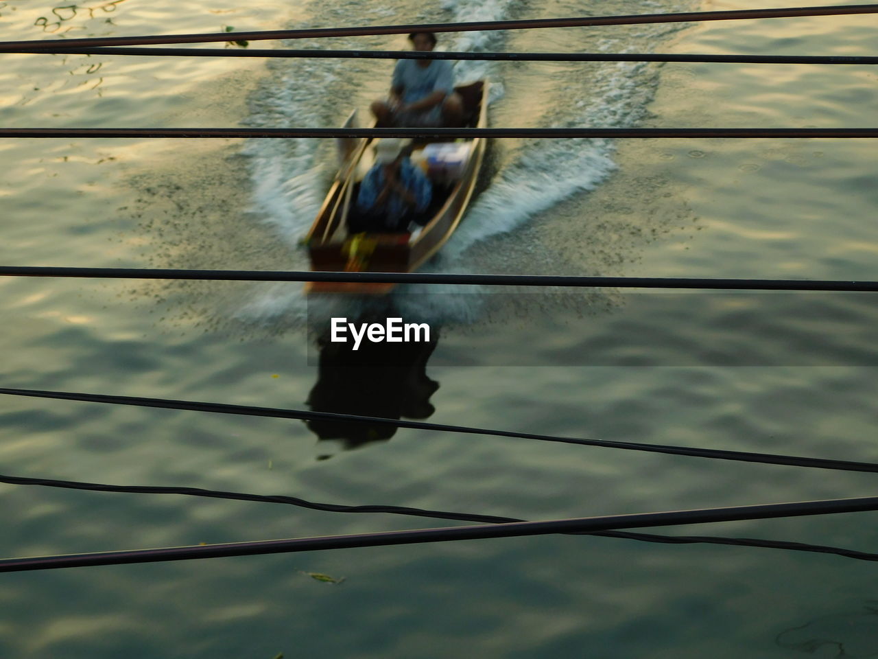 REFLECTION OF MAN IN BOAT