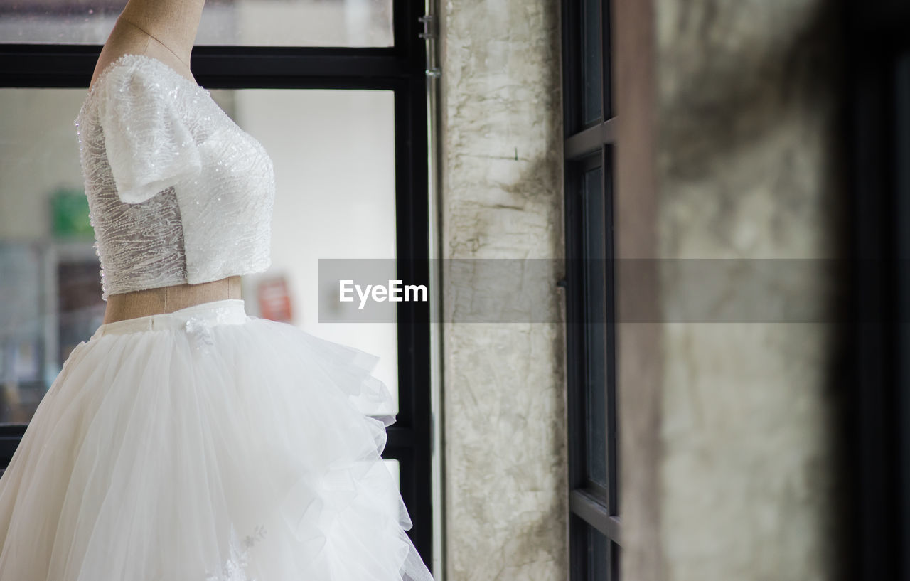 Mannequin wearing white dress in clothing store