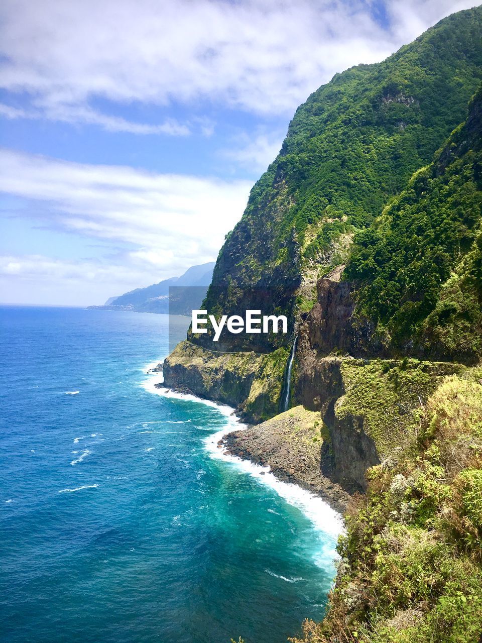 Scenic view of coastline and bay against sky