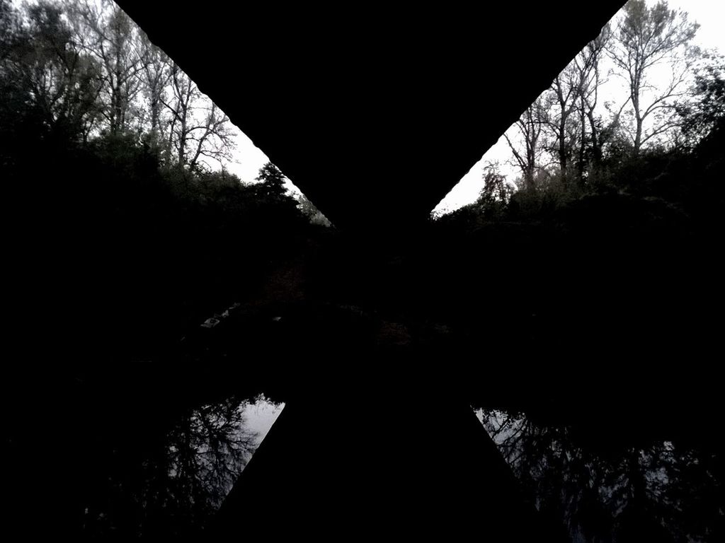 Silhouette bridge over river