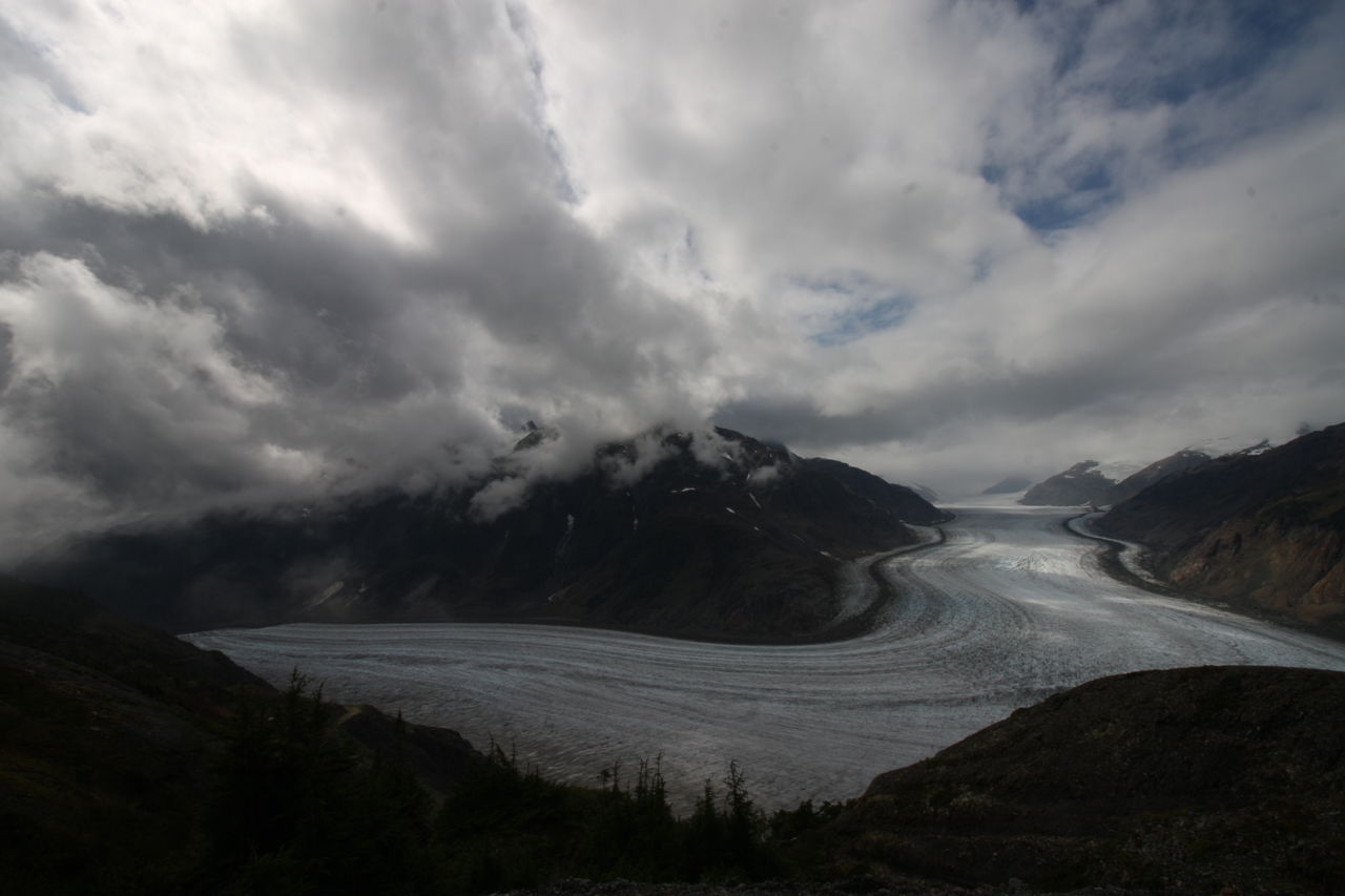 Scenic view of land and mountains against sky