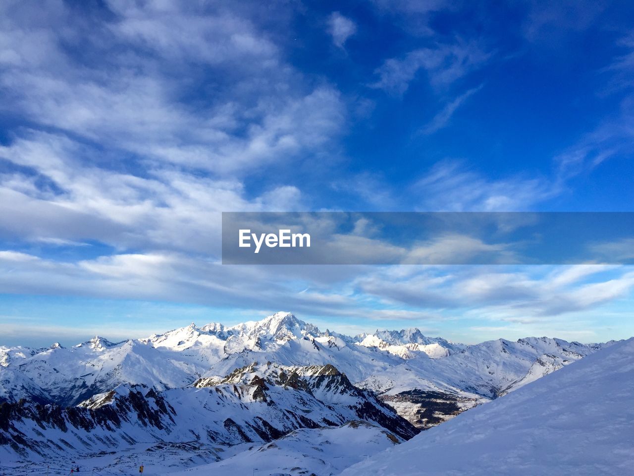 Scenic view of snowcapped mountains against blue sky in france 