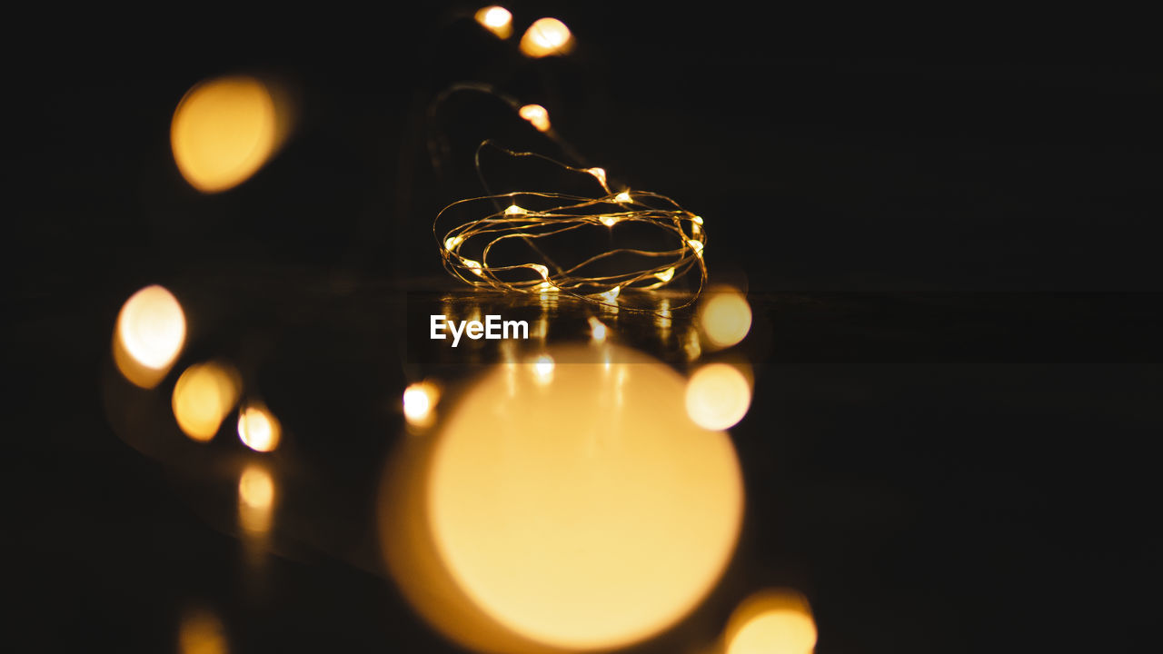 Close-up of illuminated lights on table