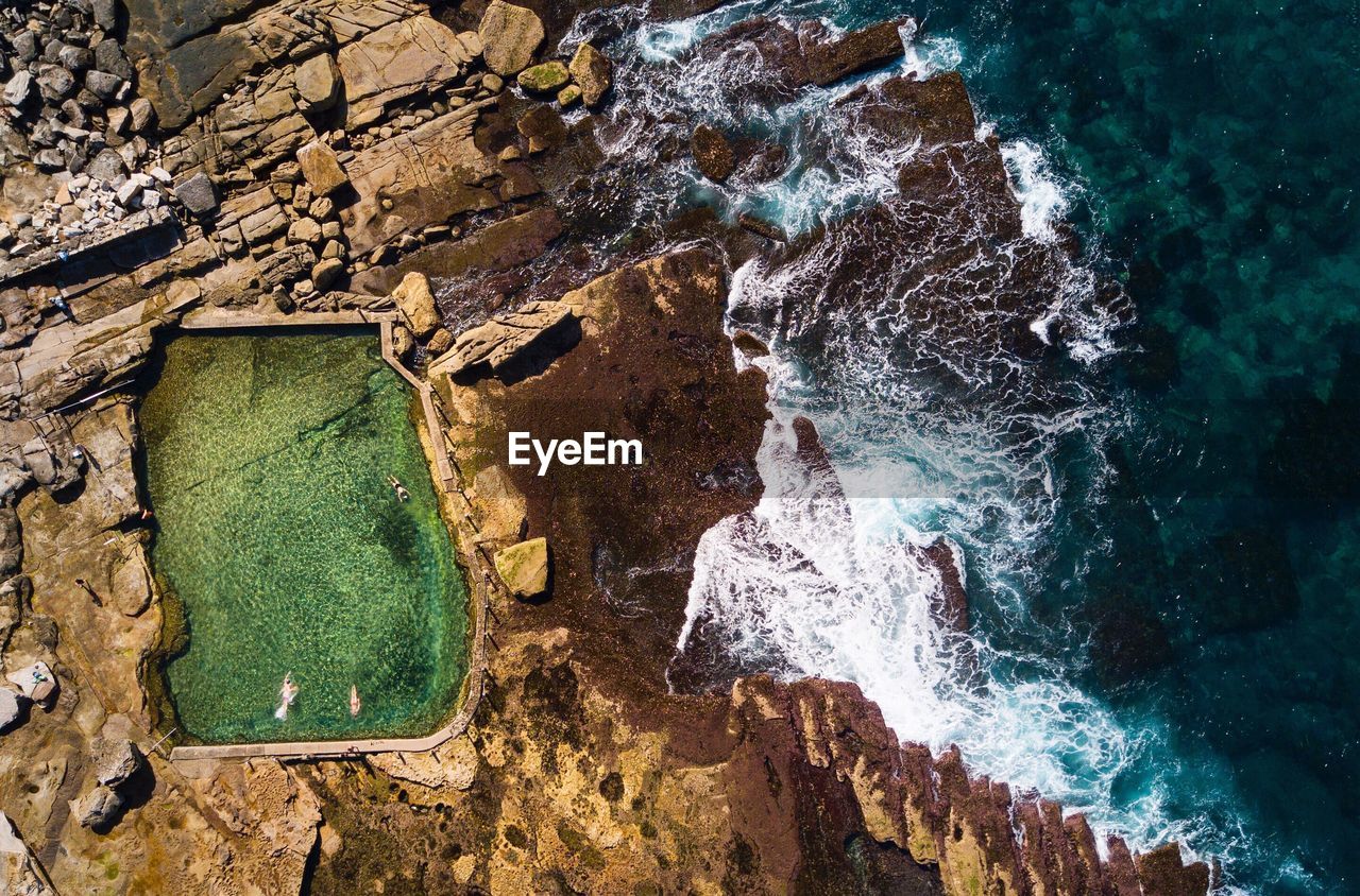  aerial view of people enjoying in swimming pool at beach