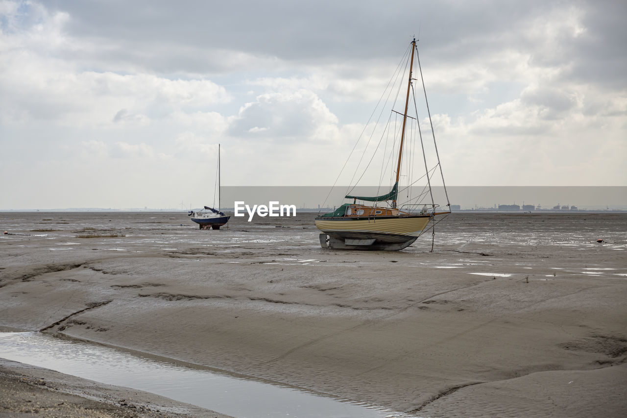 Fisherman boats stuck on the beach in low tide period in leigh-on-sea, uk.