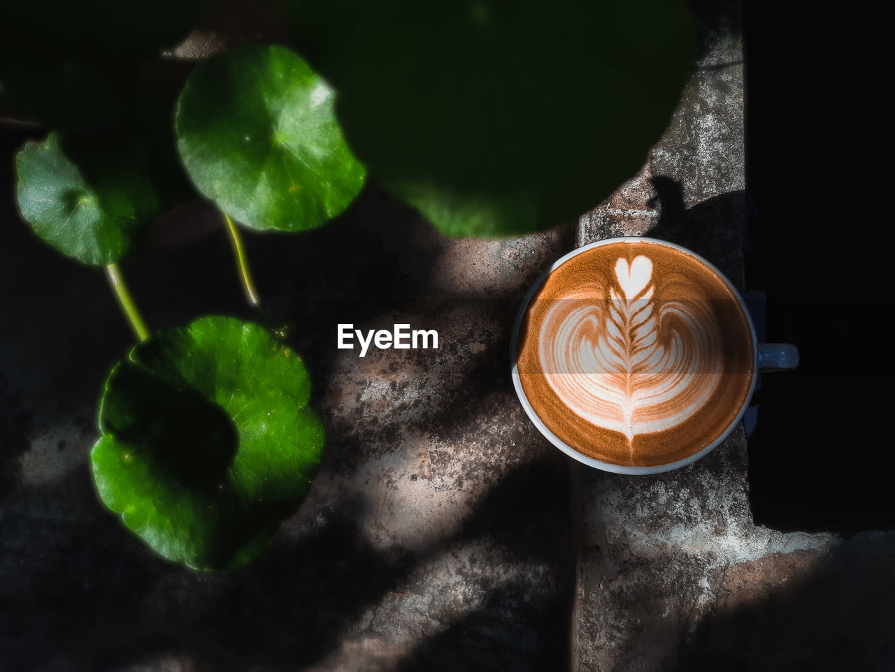 CLOSE-UP OF COFFEE ON TABLE AT SUNSET