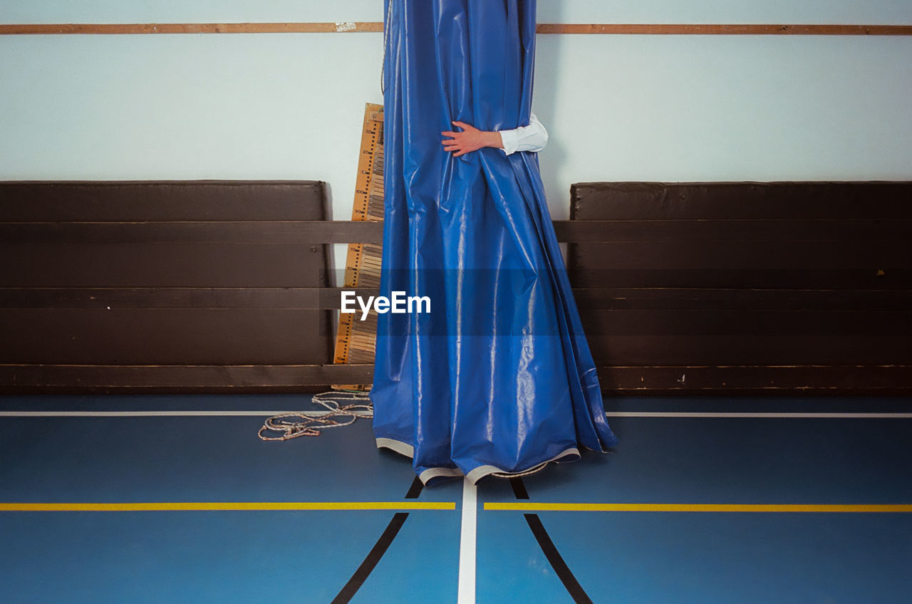  teenage boy at school graduation standing on floor at school