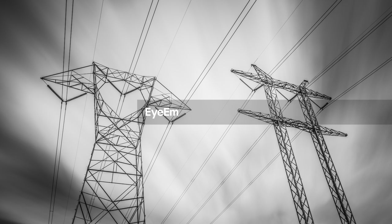 Low angle view of electricity pylon against sky