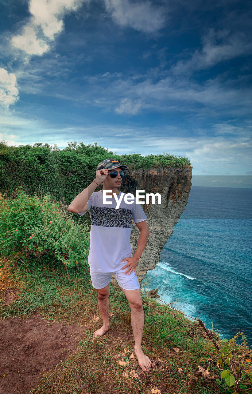 A man  standing by sea against sky