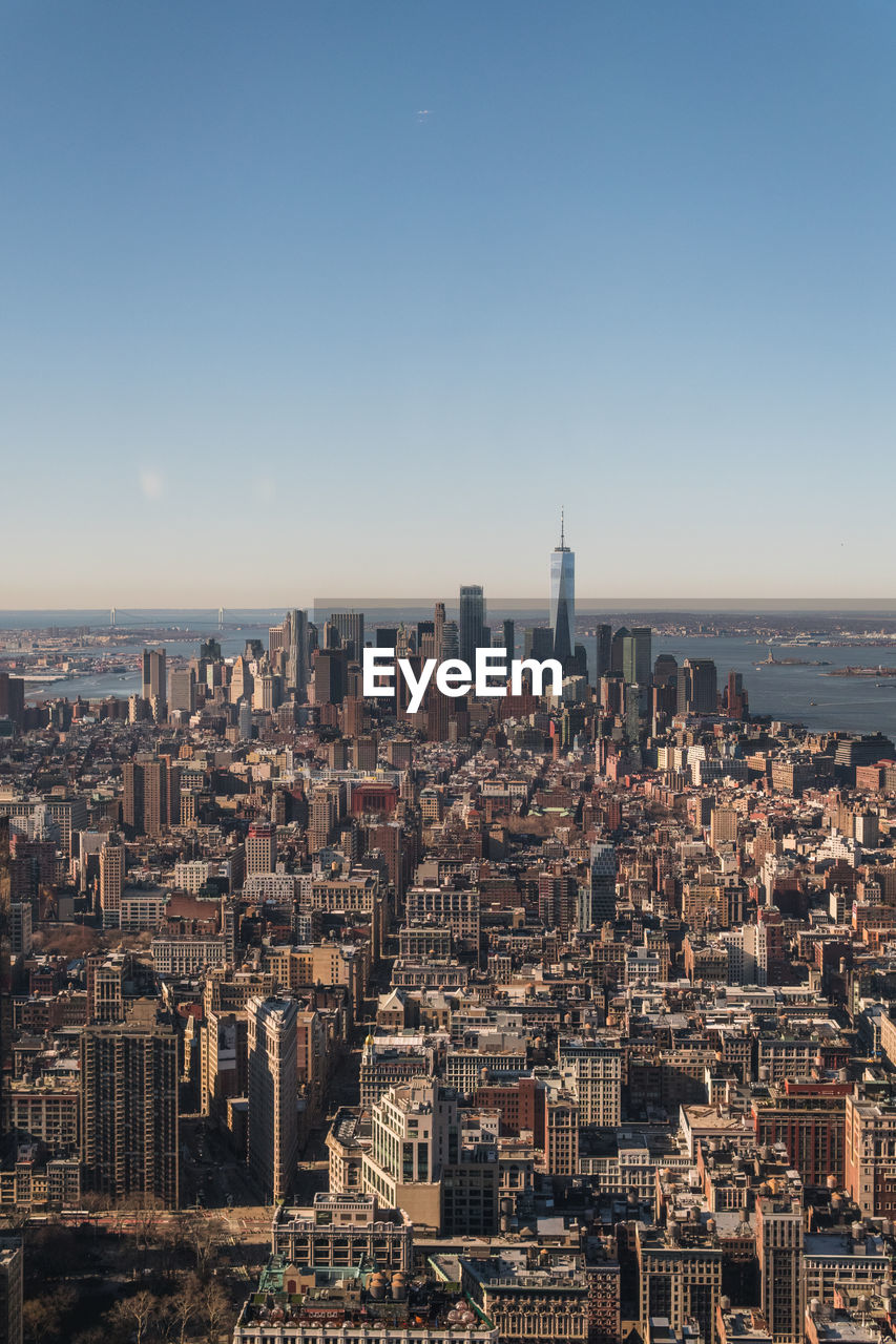 Aerial view of city buildings against clear sky