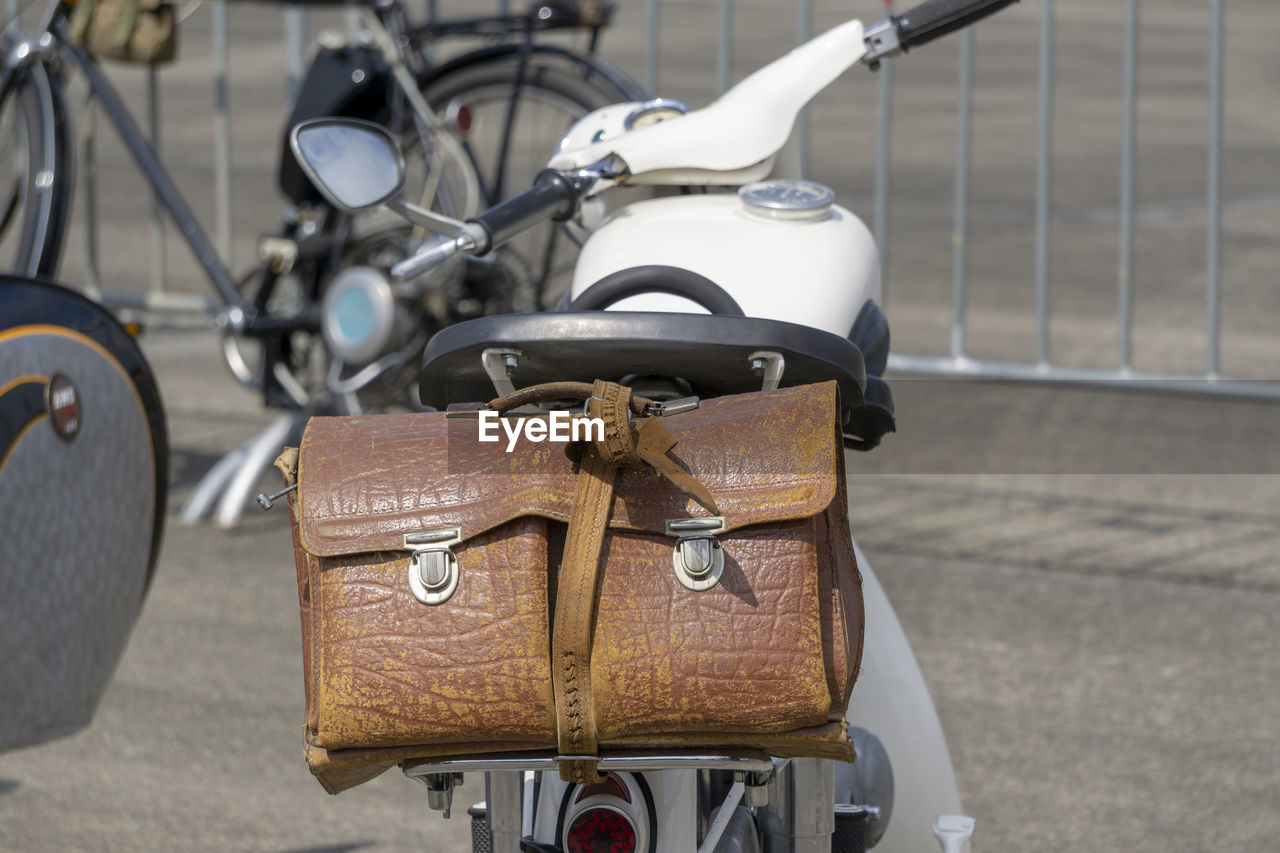 Close-up of bag on motor scooter parked in city