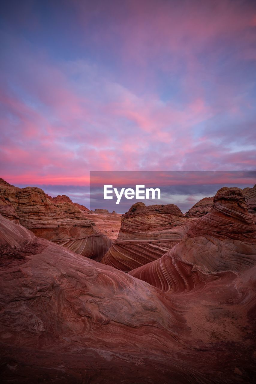 View of rock formations against cloudy sky