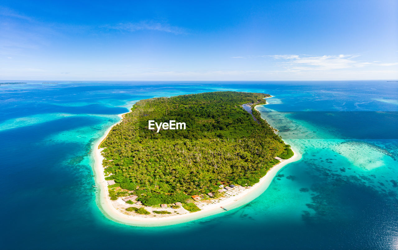 SCENIC VIEW OF ISLAND AGAINST BLUE SKY