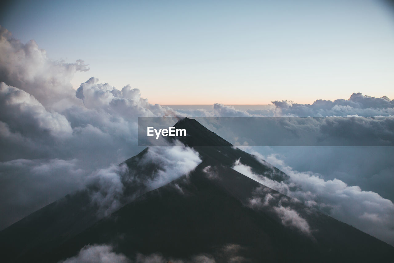 Scenic view of mountains amidst cloudscape during sunset