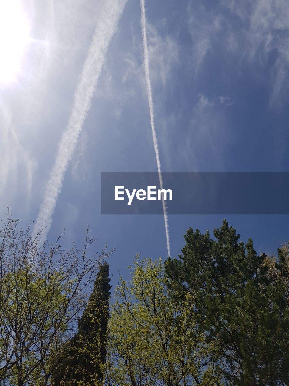 LOW ANGLE VIEW OF VAPOR TRAILS IN SKY