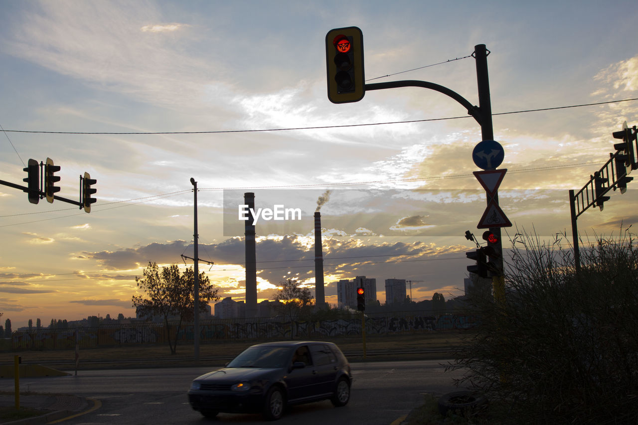 CARS ON ROAD AGAINST SKY