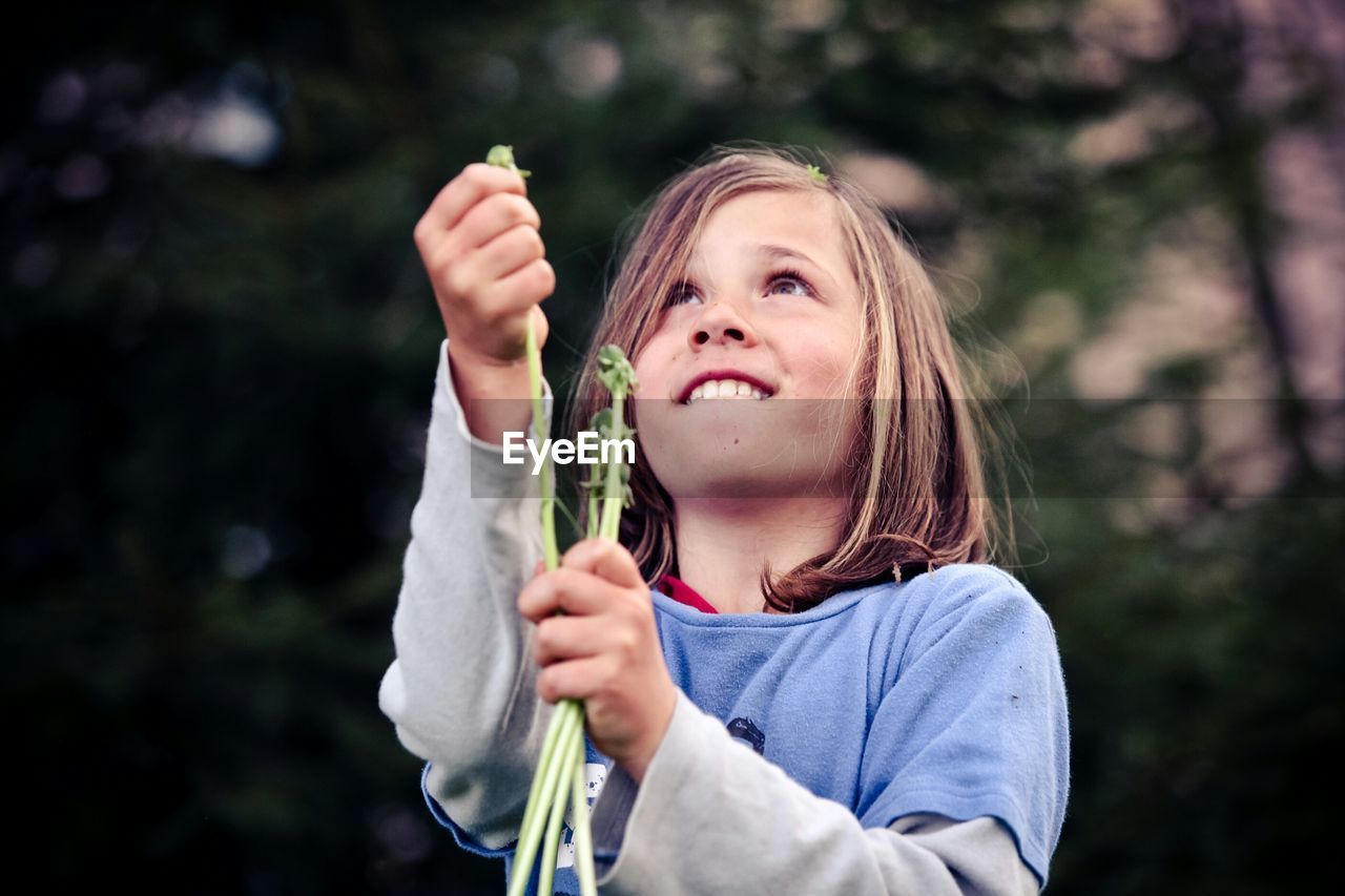 Boy holding plants