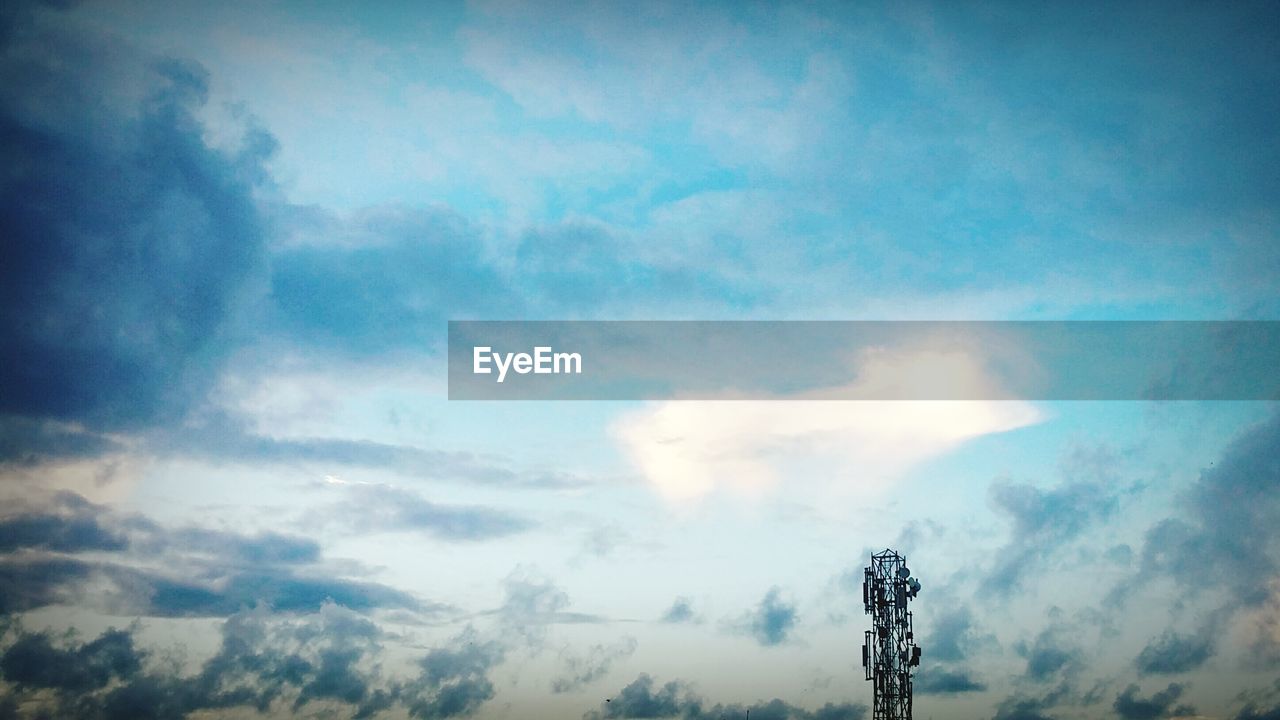 LOW ANGLE VIEW OF SKY AND ELECTRICITY PYLON AGAINST CLOUDY BLUE