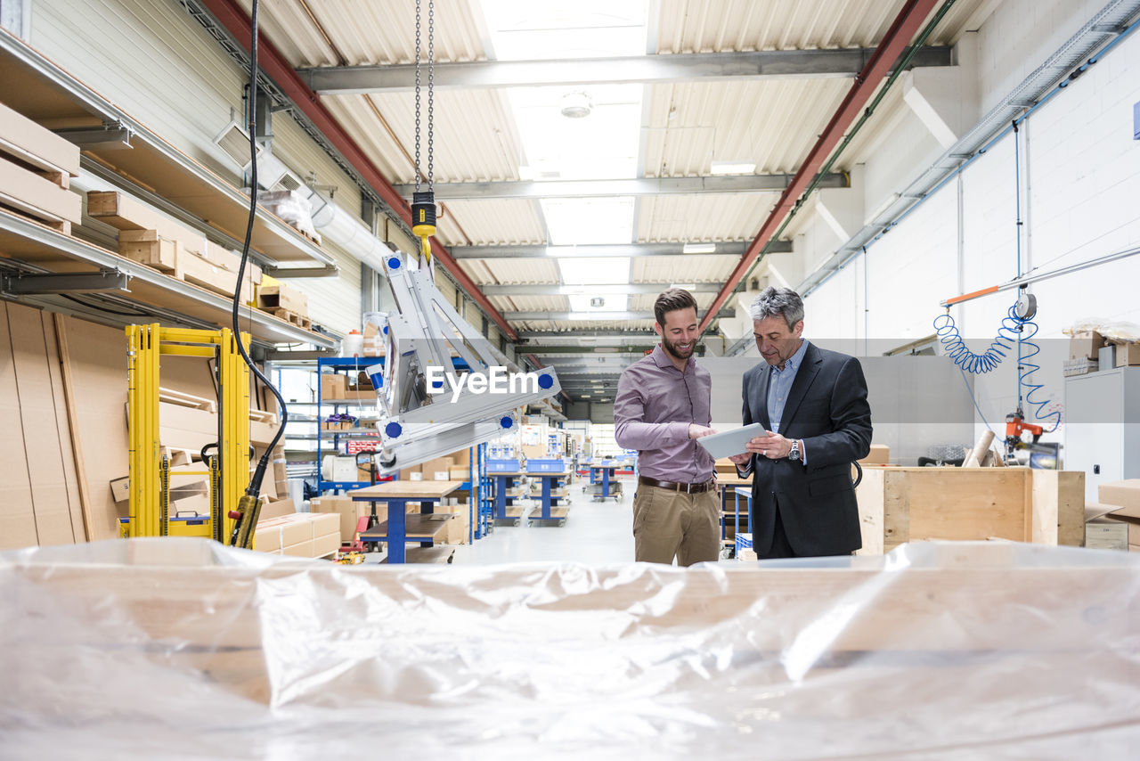 Businessmen during meeting in production hall