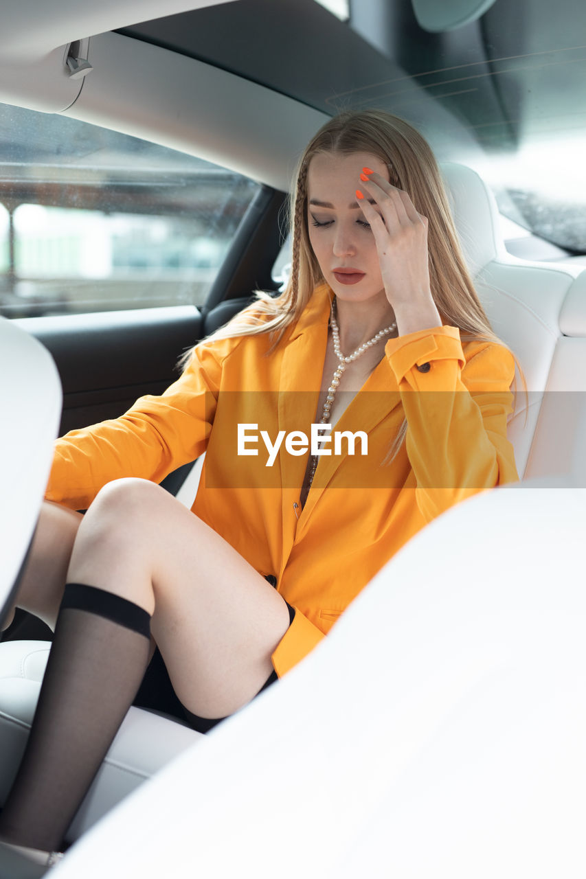 Young woman sitting in car