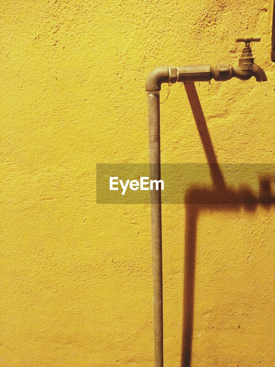 CLOSE-UP OF YELLOW SHADOW ON WALL