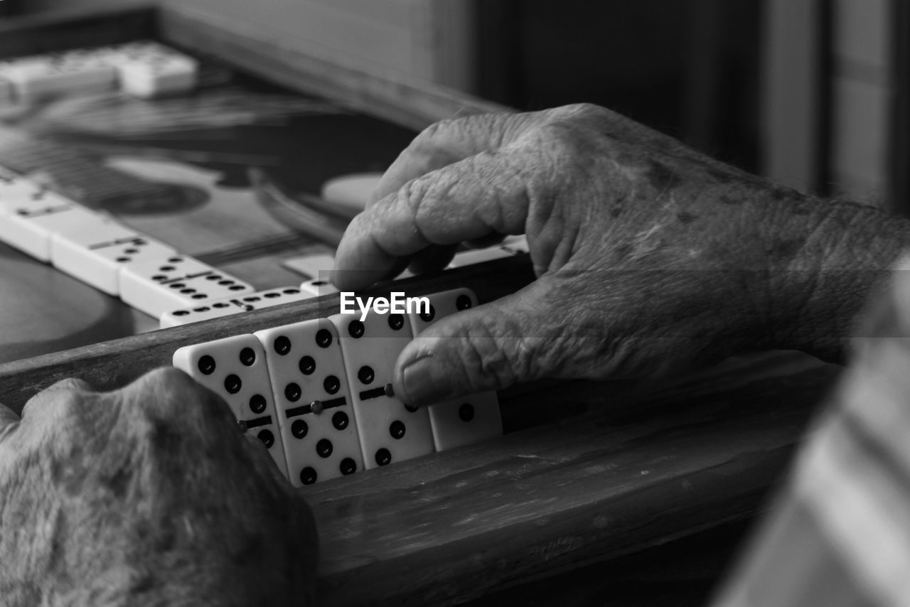 Cropped hands playing domino