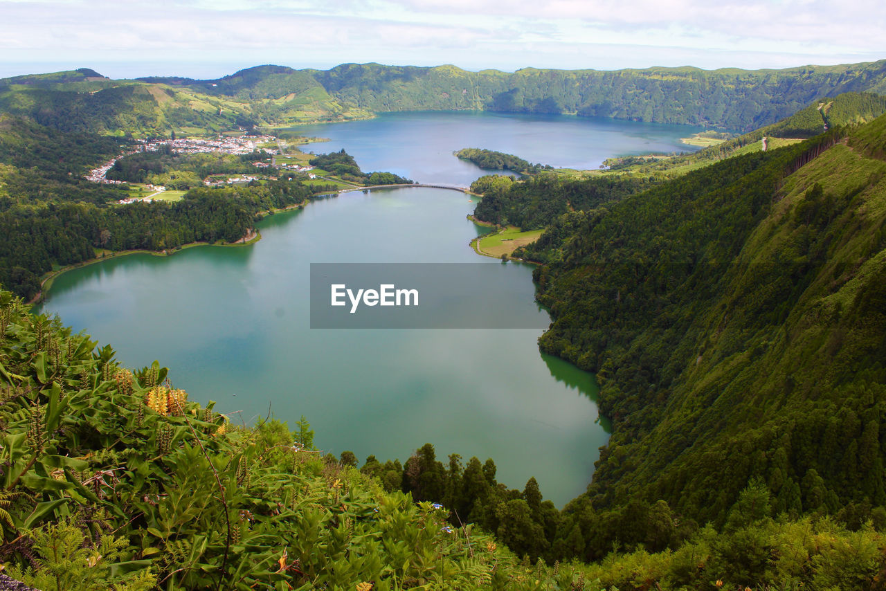 Scenic view of lake and mountains against sky