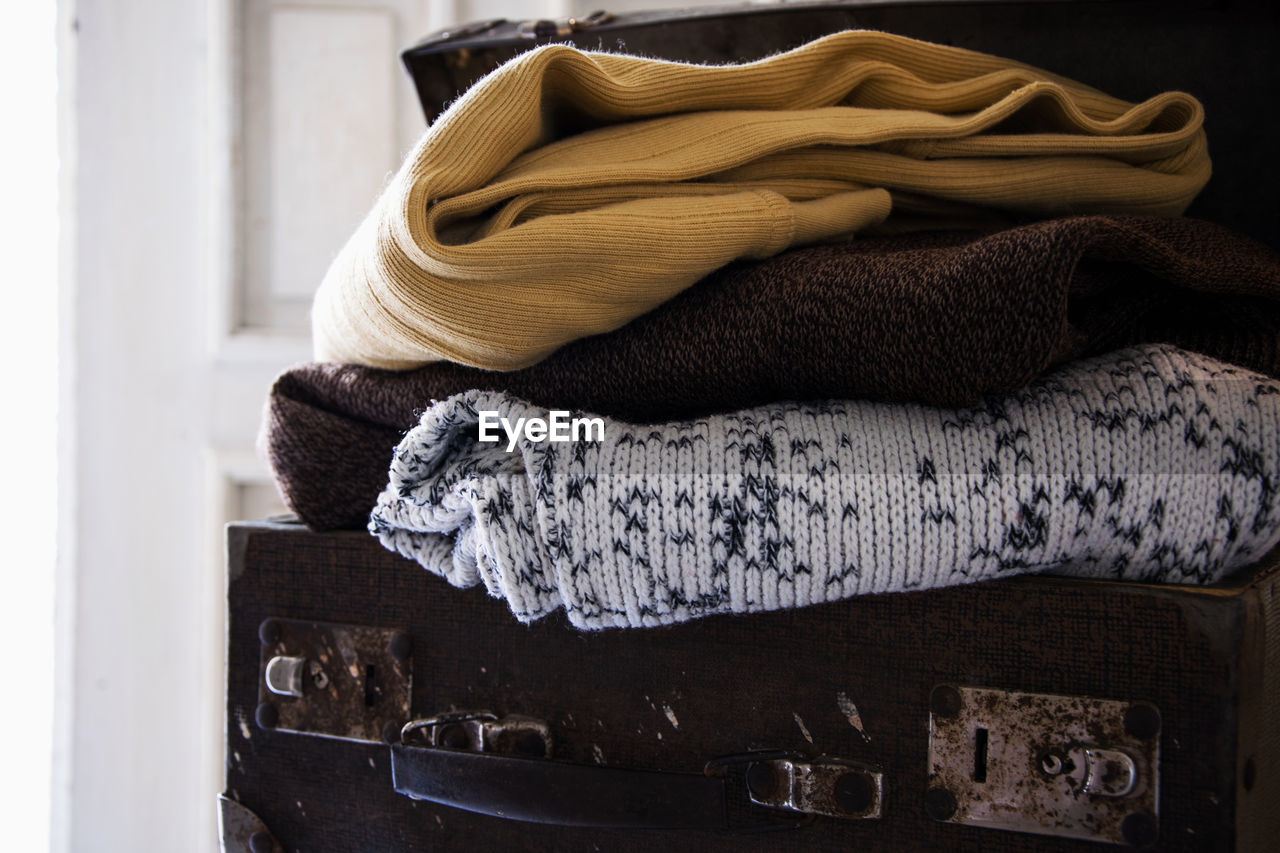 Close up of folded blankets on suitcase