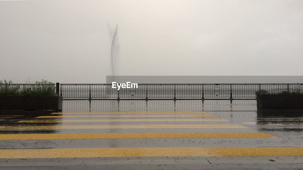 Scenic view of wet city against sky during rainy season