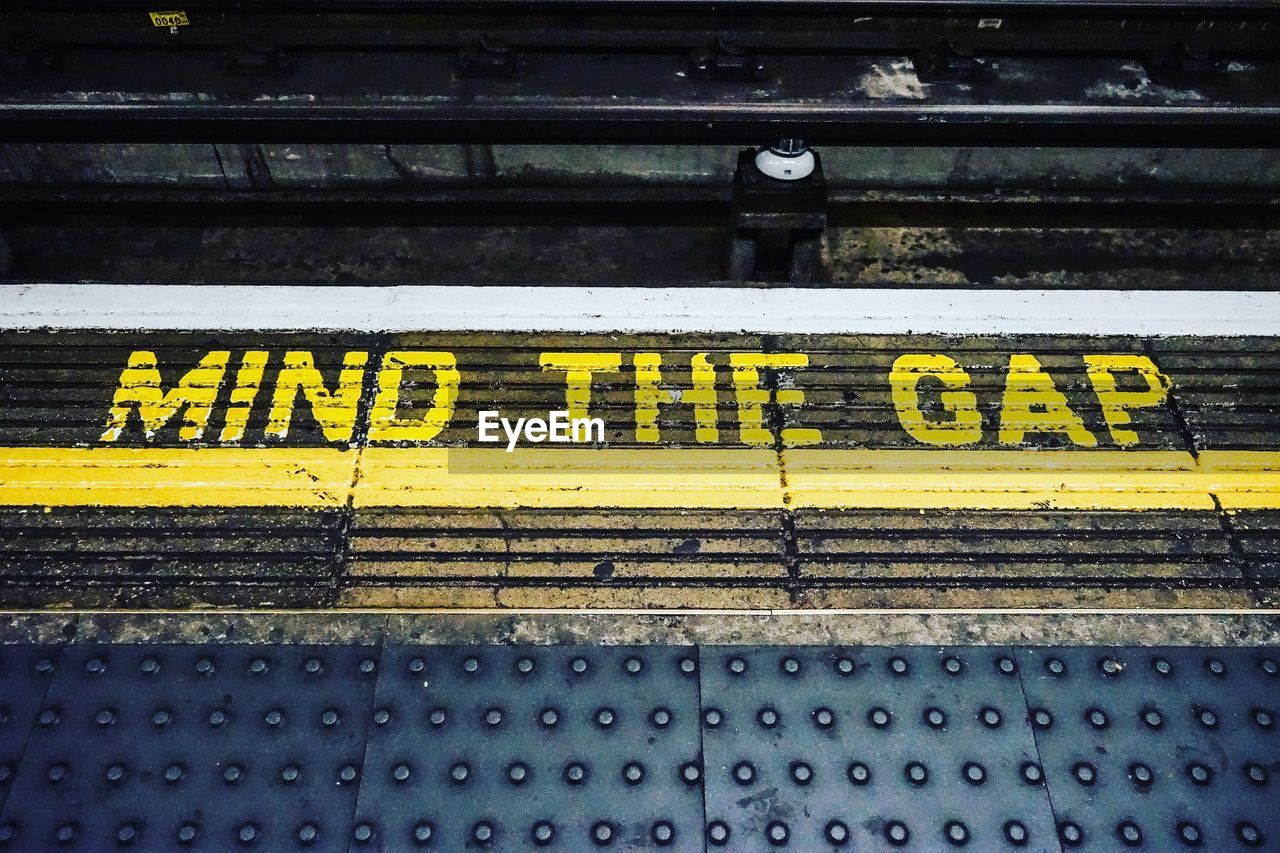 High angle view of yellow text on railroad station