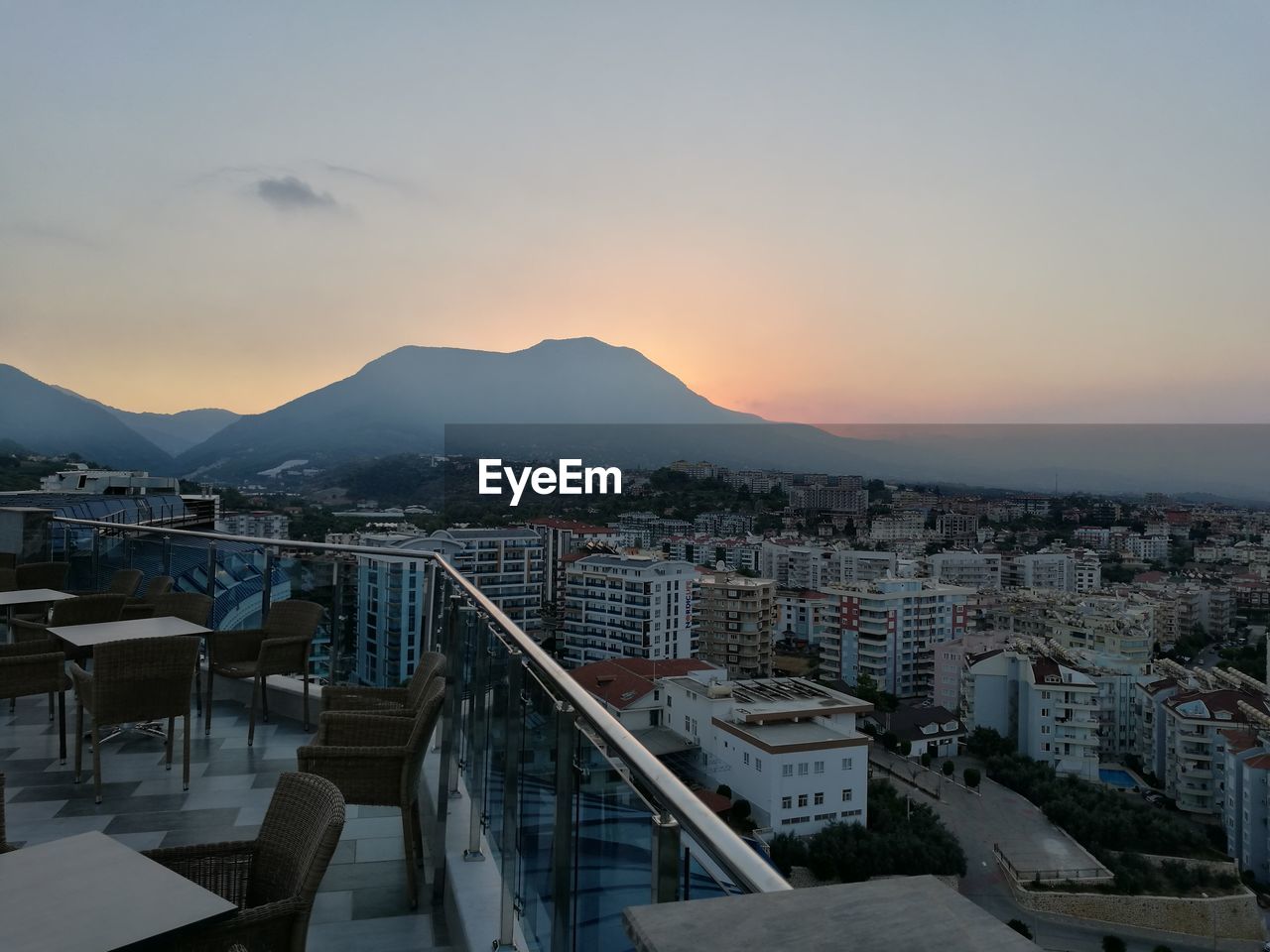 High angle view of town by sea against sky during sunset