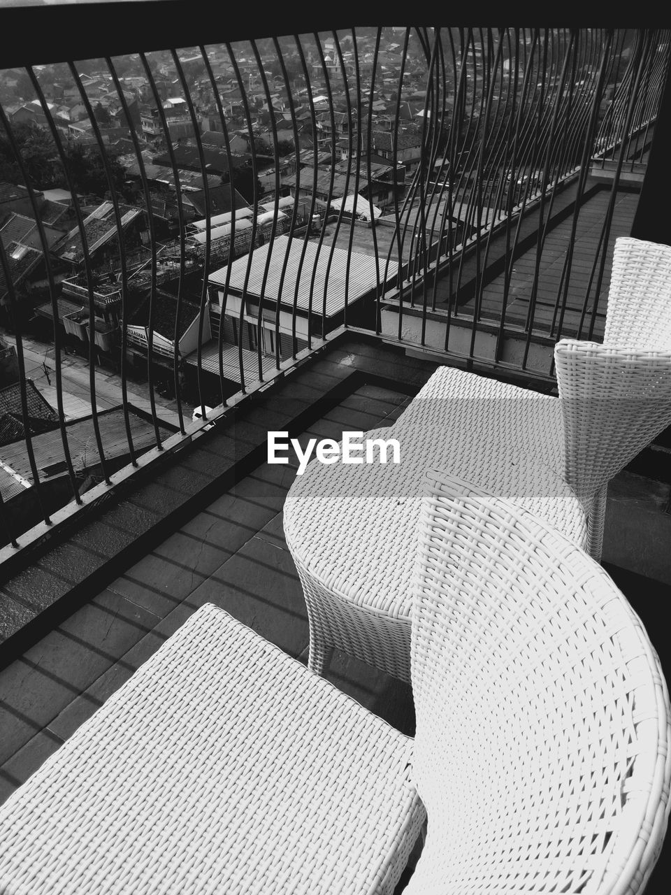 High angle view of empty chairs on balcony