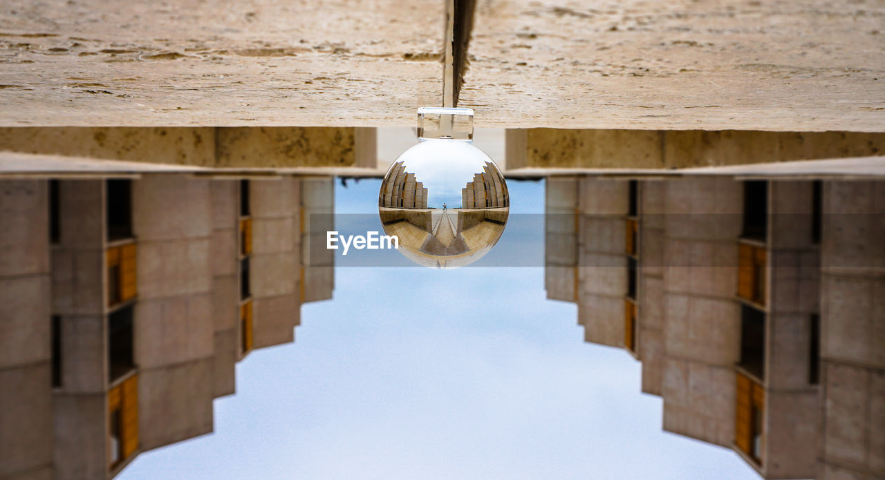 Low angle view of crystal ball with architecture 