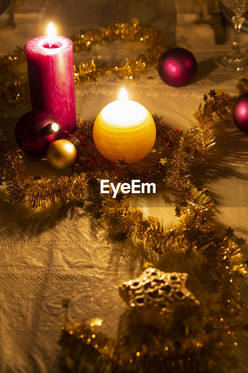 Close-up of illuminated christmas decorations on dining table