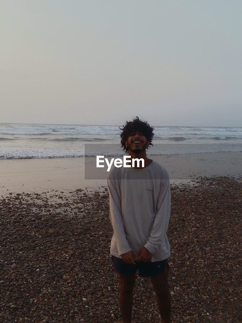 Young man standing at beach