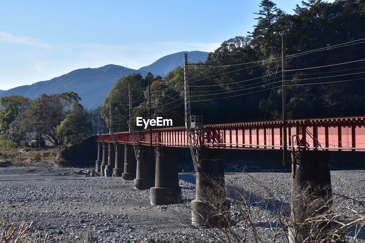 architecture, sky, nature, built structure, mountain, tree, bridge, plant, no people, transportation, transport, water, scenics - nature, land, landscape, day, outdoors, environment, travel destinations, travel, mountain range, clear sky, river, tranquility, beauty in nature