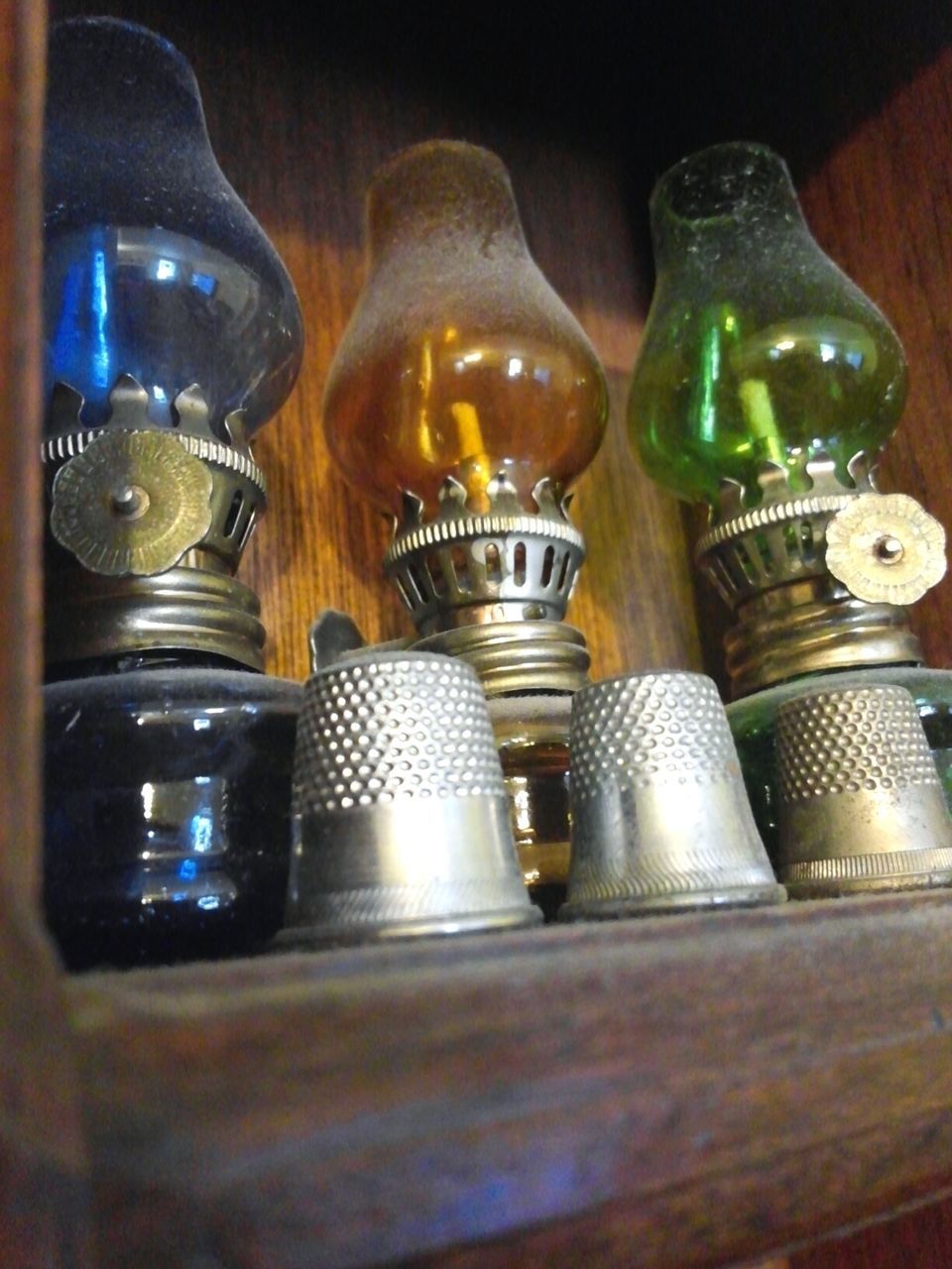 CLOSE-UP OF CANDLES IN SHELF